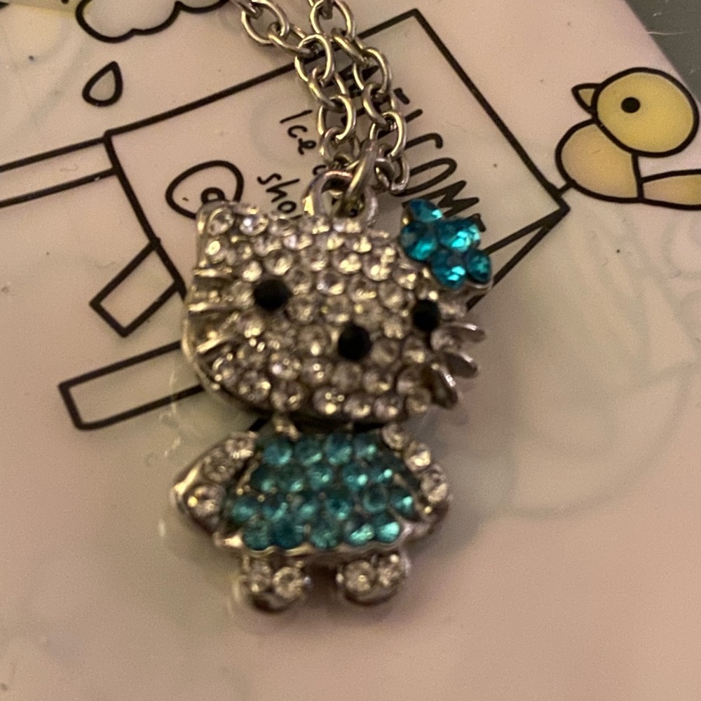 Hello Kitty Inspired necklace.  Rhinestones and lower body movement.  Unique!